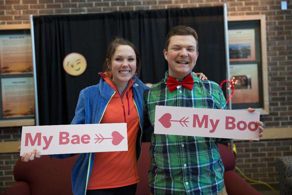 boy and girl posing with signs